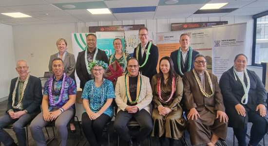 A group of different people from various backgrounds posing together.