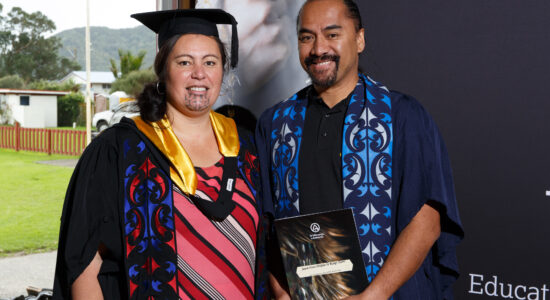 Two people in graduation attire.