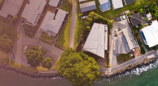 A birds eye view of a coast line and houses.