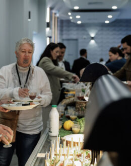 People gathered around a buffet table.