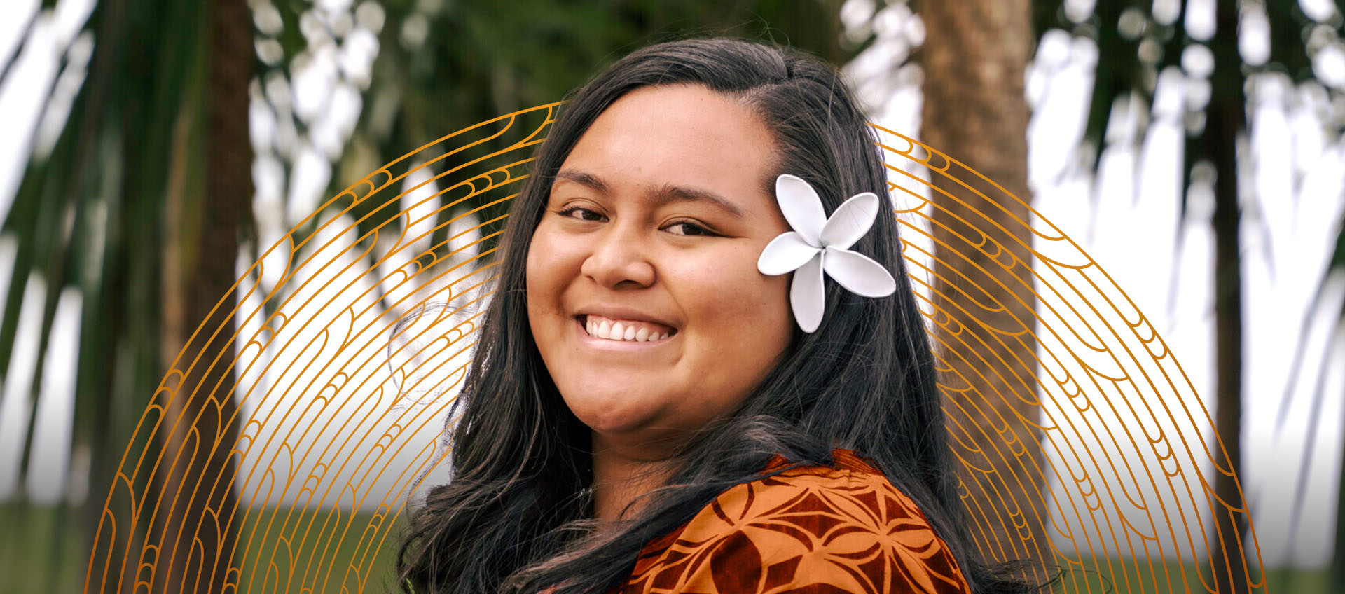 A young Pacific Island woman smiles at the camera with a blurred background of coconut trees behind her.