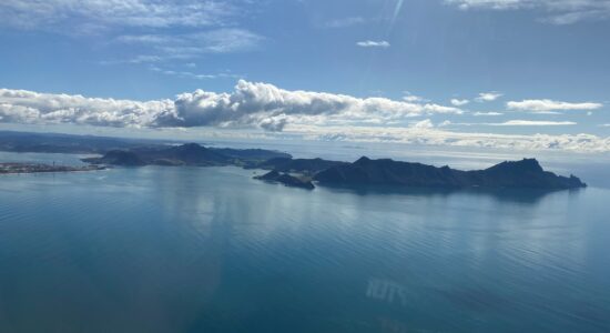 A beautiful scenery of an ocean and mountains.