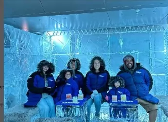 A group of people wearing blue winter jackets.