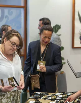 A group of people picking up their lanyards from the front desk.